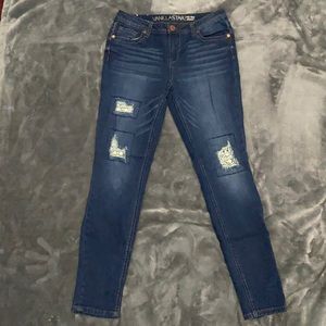 Mid Rise Skinny jeans. Distressed but with design